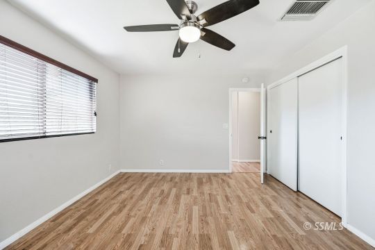 407 South Sunland Street Ridgecrest, CA 93555 - Photo 21 of 28 wooden floor in an empty room with a window