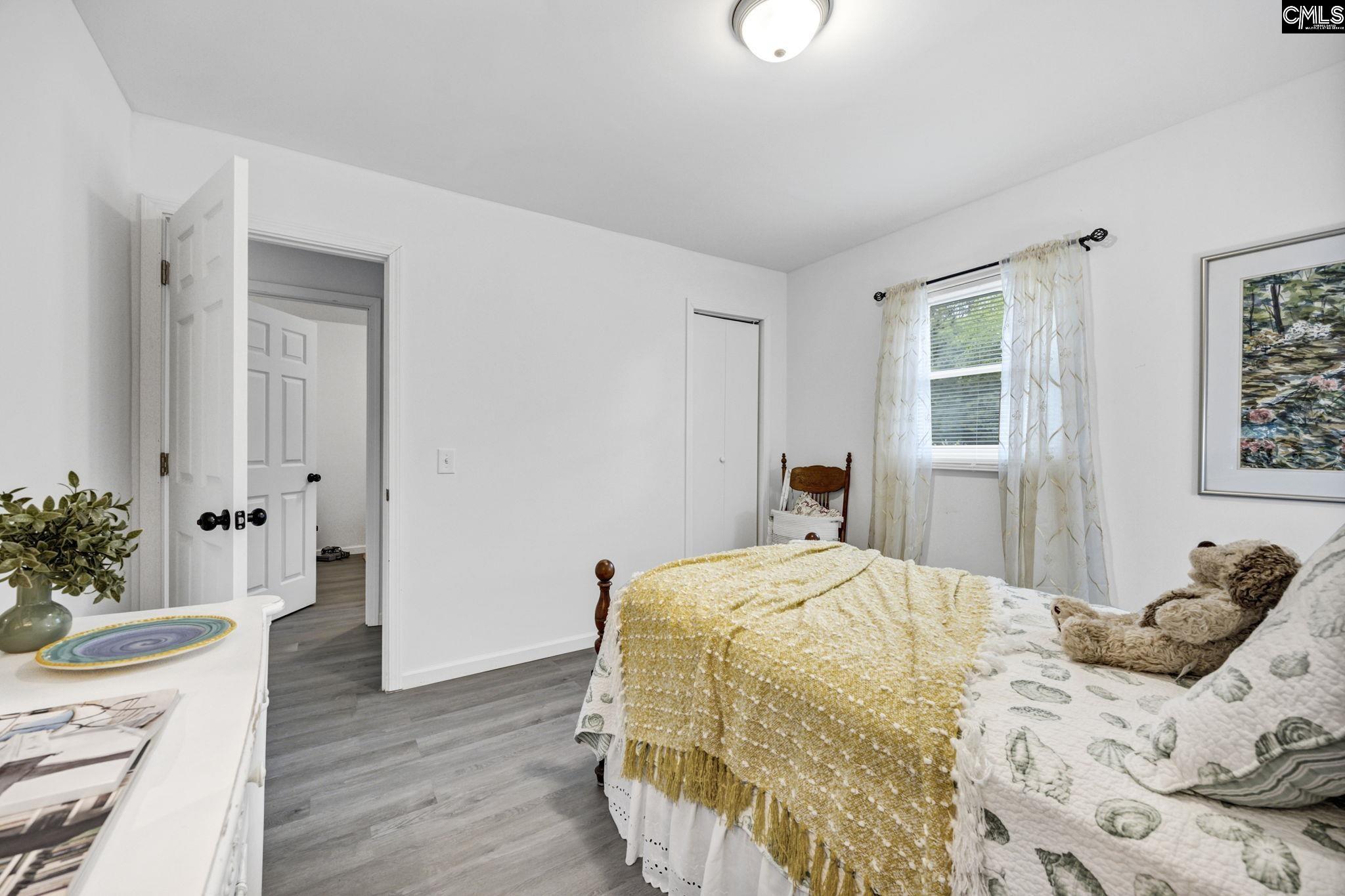 8107 Black River Road Rembert, SC 29128 - Photo 28 of 38 a bedroom with a bed and wooden floor