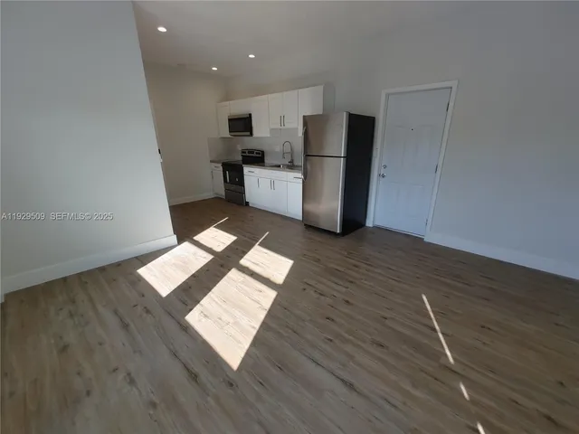 a view of workspace with wooden floor and window
