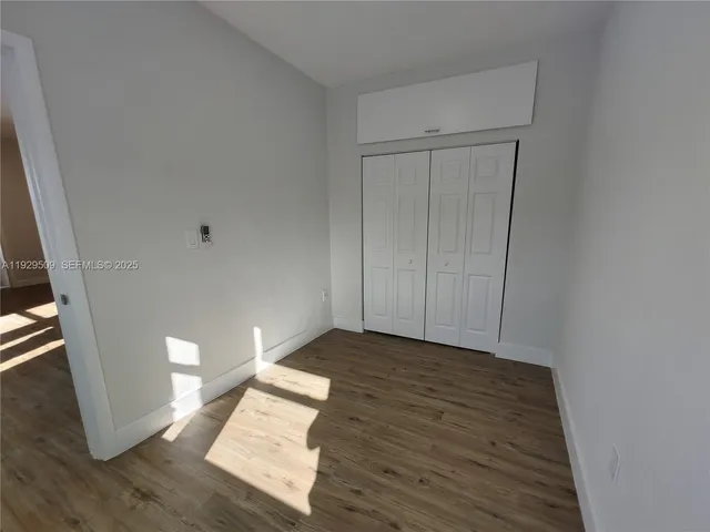 a view of an empty room and wooden floor