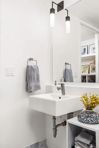 a view of walk in closet with clothes shoes and a washer dryer