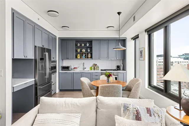 a kitchen with stainless steel appliances granite countertop a refrigerator and a sink