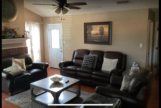a living room with furniture rug and window