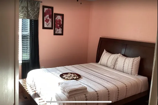 a bedroom with a bed and a night stand