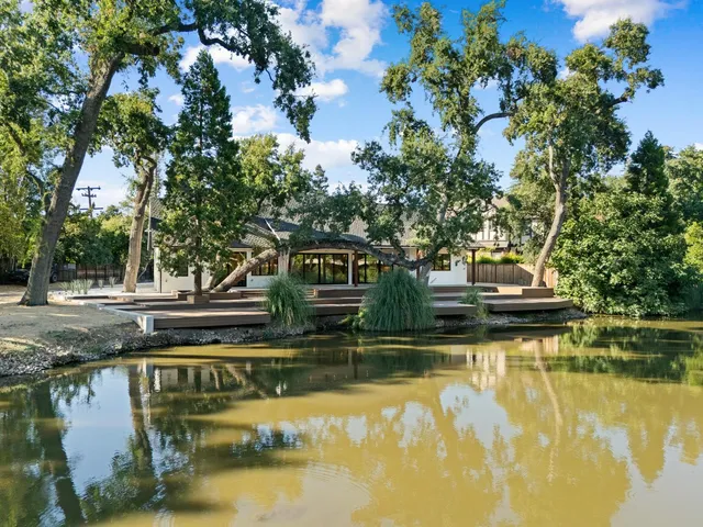 a view of swimming pool with trees in the background