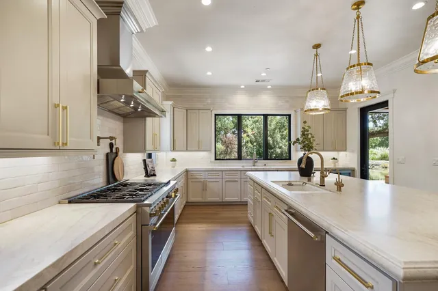 a view of staircase with a large window and wooden floor