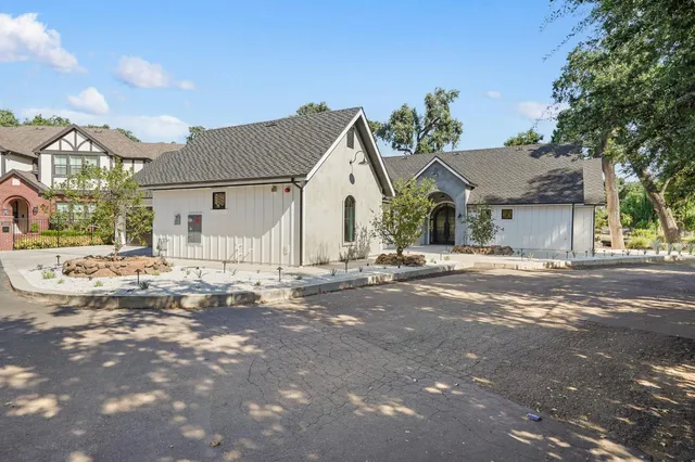 a living room with furniture large window and wooden floor