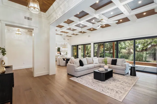 a living room with furniture and large windows