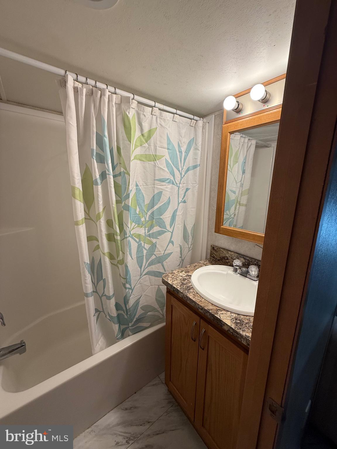 515 Corsons Tavern Road, Unit H61 Ocean View, NJ 08230 - Photo 12 of 19 a bathroom with a granite countertop sink and a mirror