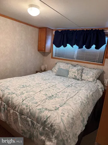 a view of a house with a backyard and sitting area