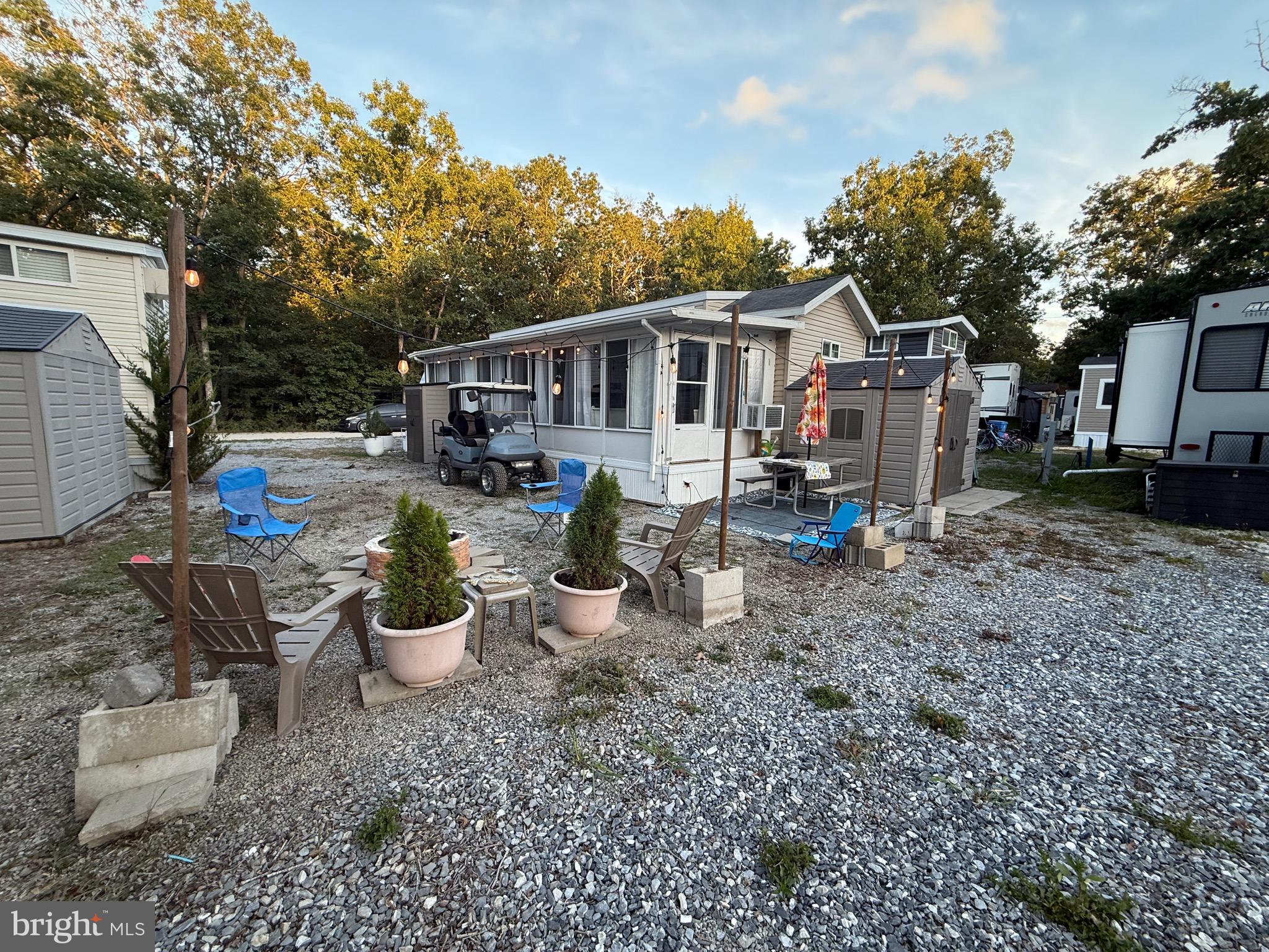 515 Corsons Tavern Road, Unit H61 Ocean View, NJ 08230 - Photo 18 of 19 a view of a house with a backyard and sitting area