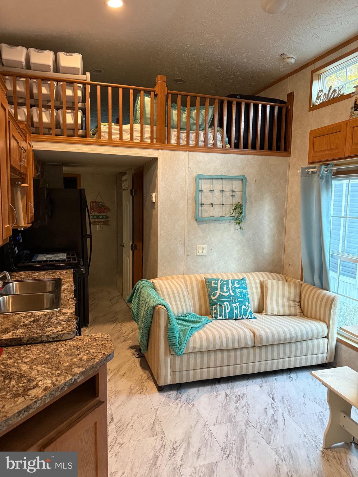 515 Corsons Tavern Road, Unit H61 Ocean View, NJ 08230 - Photo 4 of 19 a living room with furniture and a fireplace