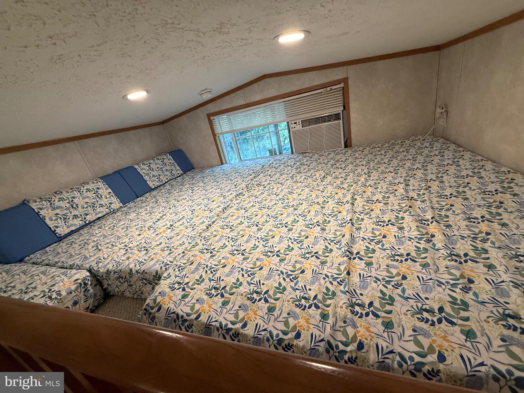 515 Corsons Tavern Road, Unit H61 Ocean View, NJ 08230 - Photo 9 of 19 a large bed sitting in a bedroom next to a window