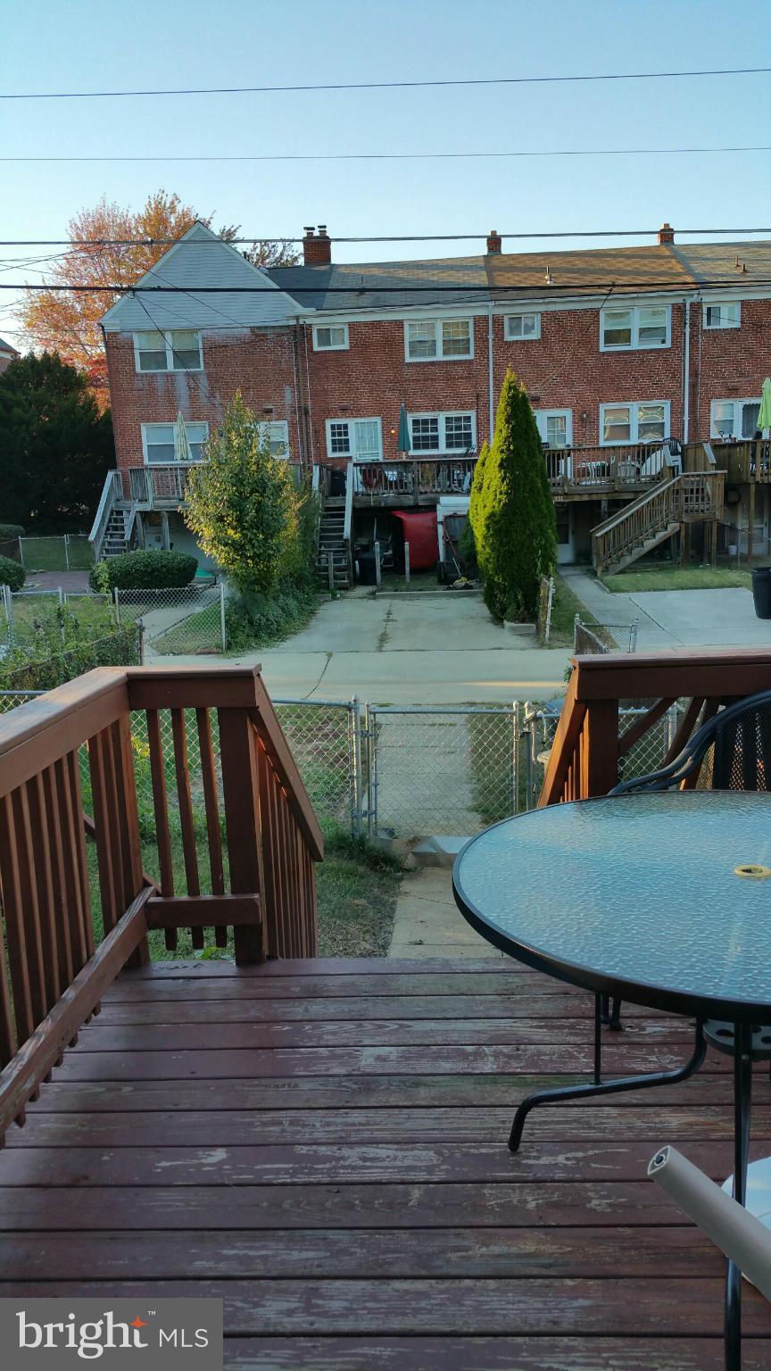 1528 Clairidge Road Baltimore, MD 21207 - Photo 14 of 14 a balcony with wooden floor table and chairs