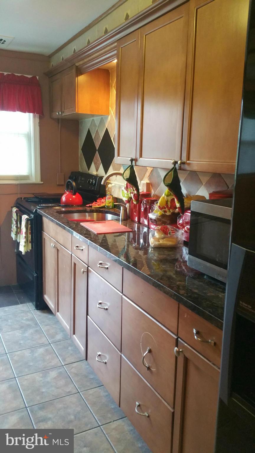 1528 Clairidge Road Baltimore, MD 21207 - Photo 8 of 14 a kitchen with sink and mirror