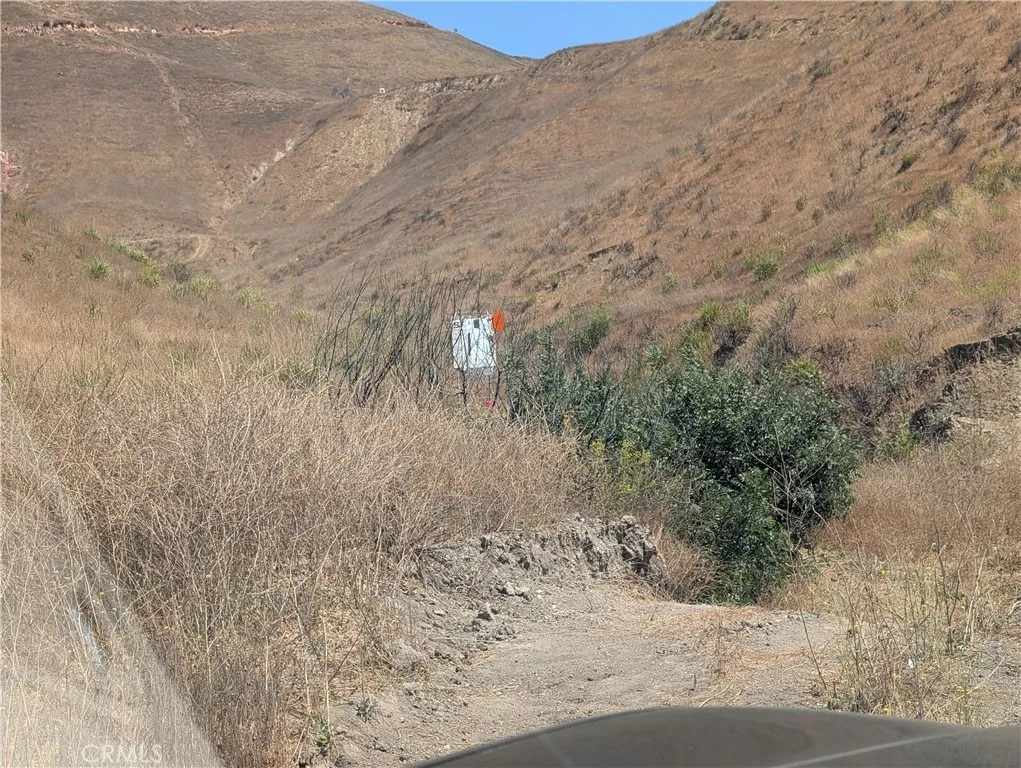 462 Waters Road Moorpark, CA 93021 - Photo 4 of 12 a view of a dry yard with mountains and wooden fence
