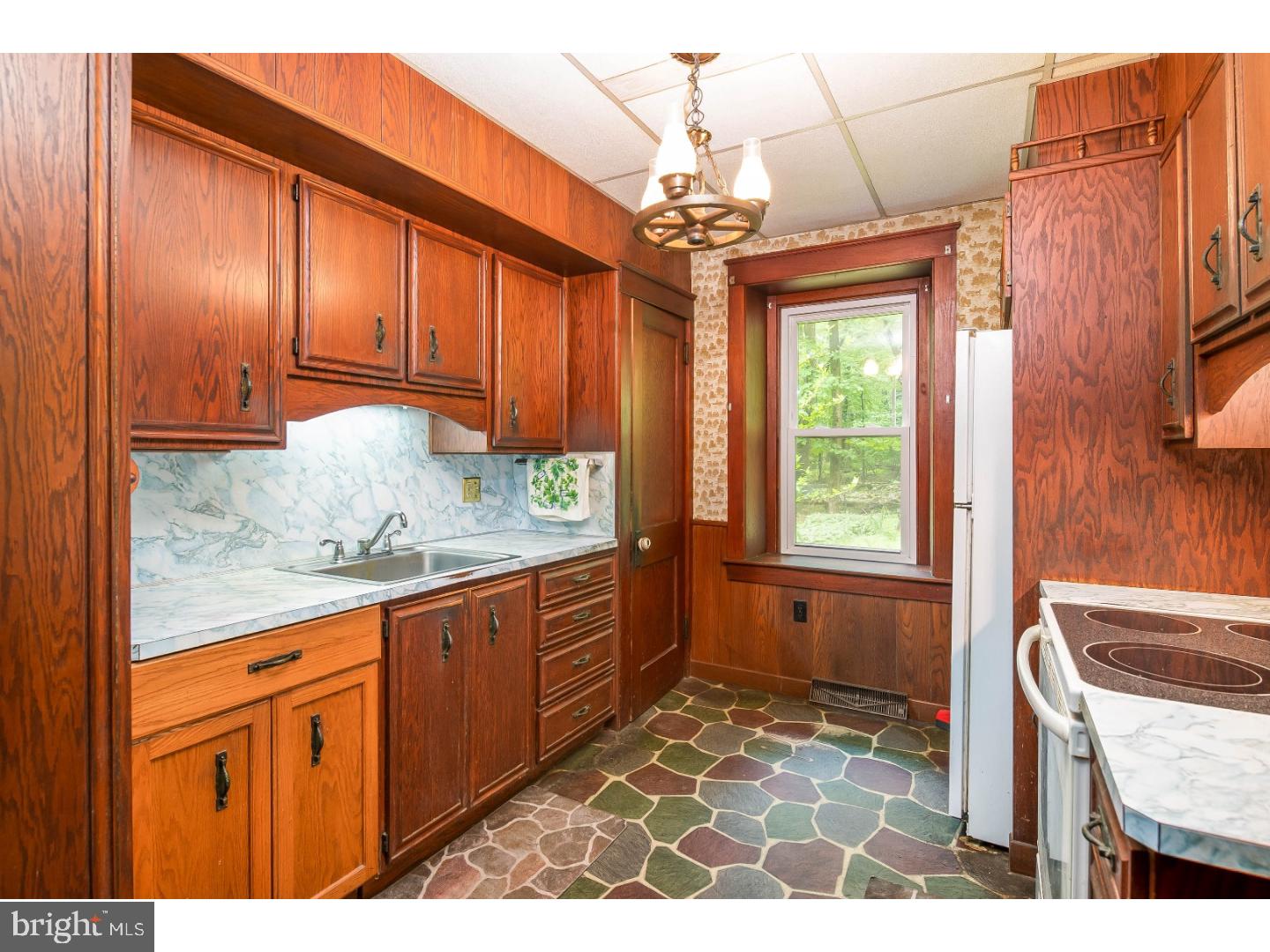 19 Petsch Road Reading, PA 19606 - Photo 15 of 19 a kitchen with granite countertop wooden cabinets a stove a oven and a dining table