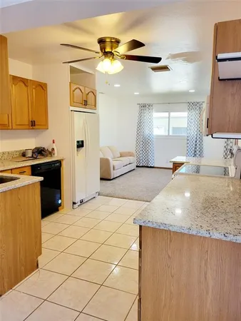 a kitchen with stainless steel appliances granite countertop a sink and a stove