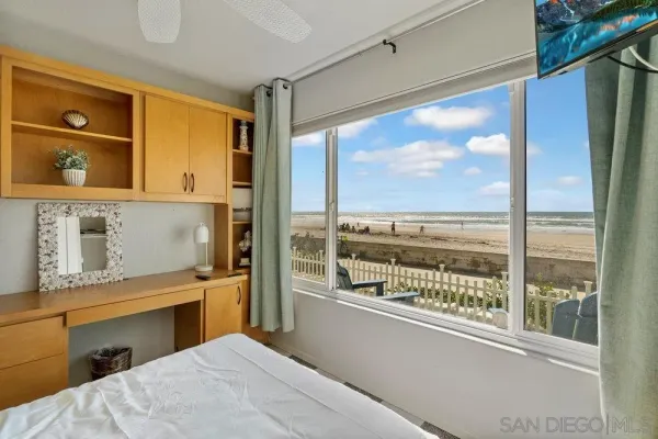 a bedroom with a large window and walk in closet
