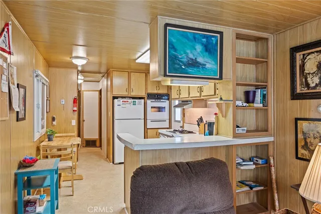 a living room with furniture and paintings on the wall