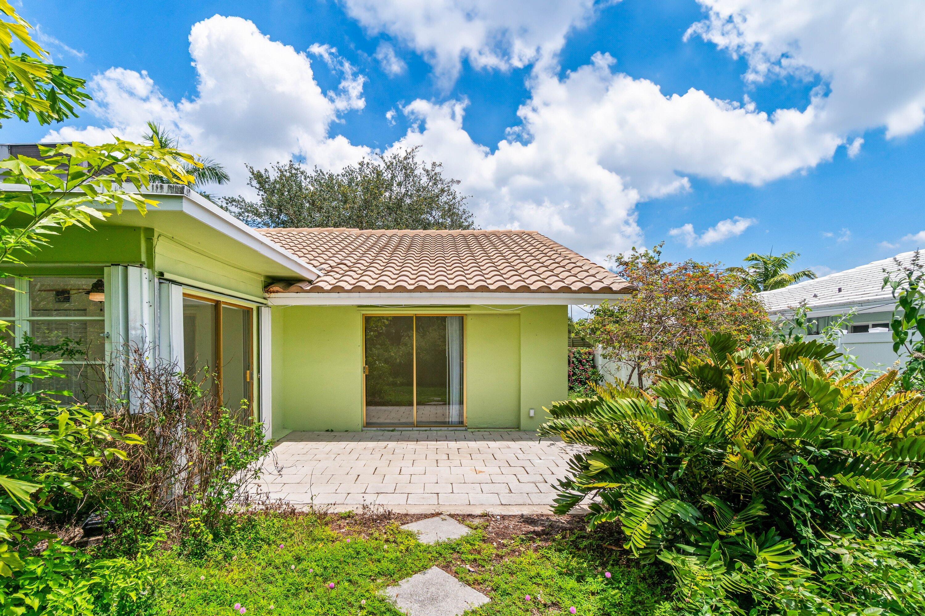 1290 Southwest 8th Street Boca Raton, FL 33486 - Photo 23 of 29 a front view of a house with a garden