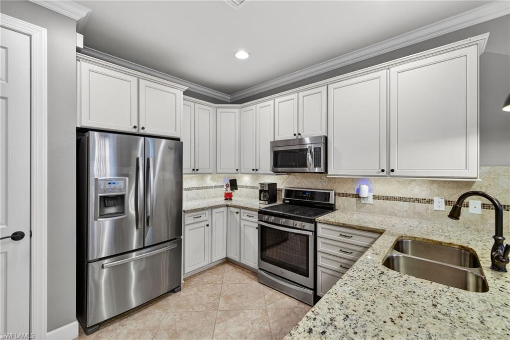 20105 Torch Key Way Estero, FL 33928 - Photo 11 of 29 a kitchen with stainless steel appliances granite countertop a refrigerator sink and stove