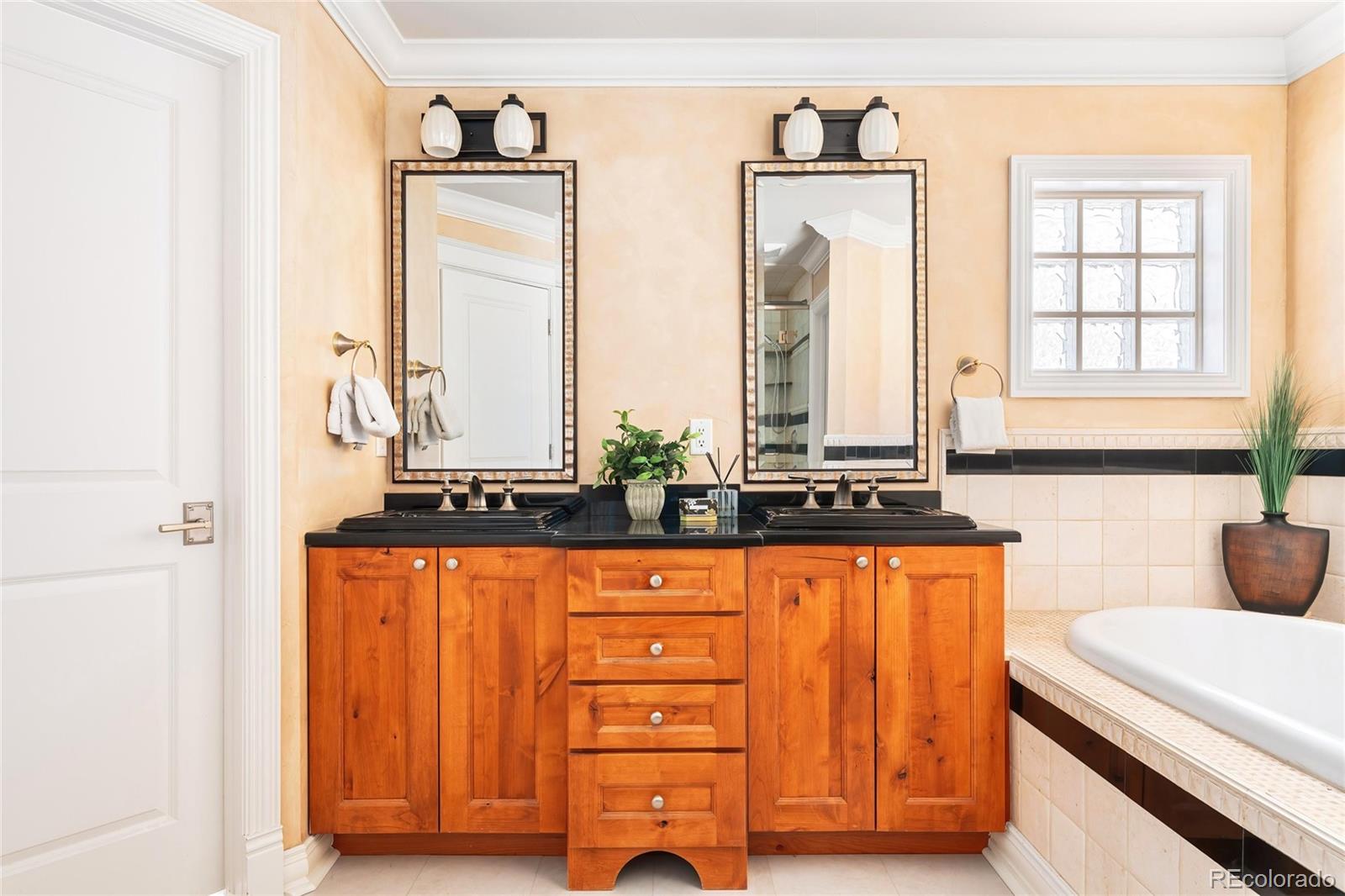 747 South Emerson Street Denver, CO 80209 - Photo 18 of 48 a bathroom with a sink and a bathtub