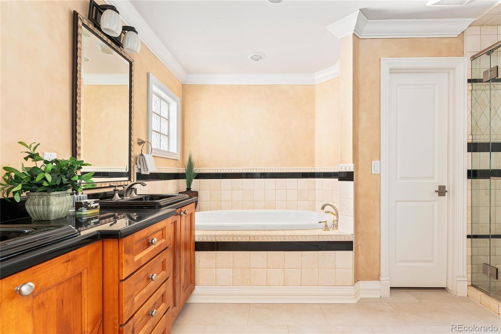 747 South Emerson Street Denver, CO 80209 - Photo 19 of 48 a bathroom with a granite countertop sink and a bathtub