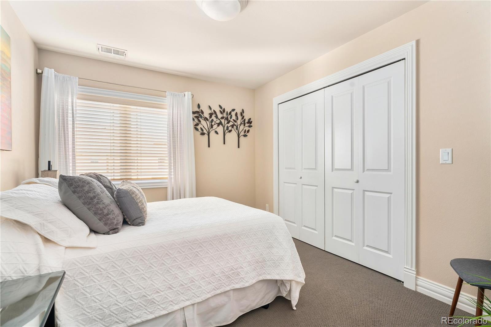 747 South Emerson Street Denver, CO 80209 - Photo 22 of 48 a bedroom with a bed and a window