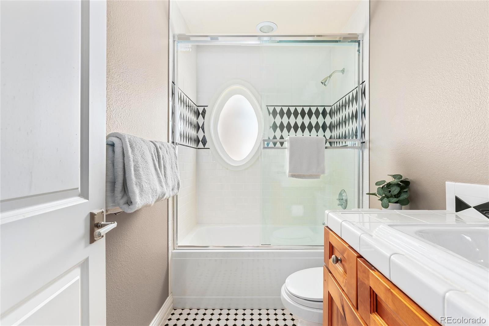 747 South Emerson Street Denver, CO 80209 - Photo 26 of 48 a bathroom with a granite countertop sink toilet and a bathtub