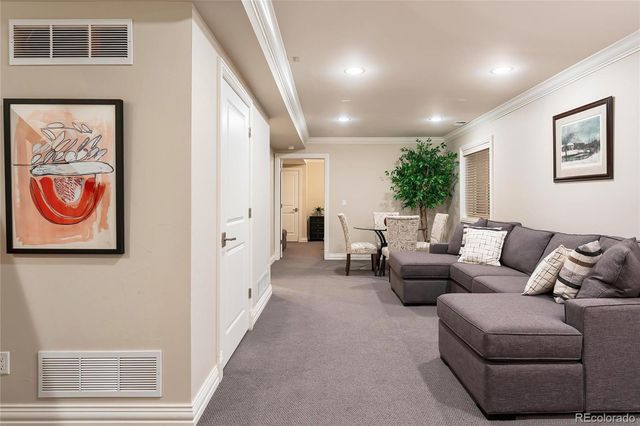 a living room with furniture and a entryway