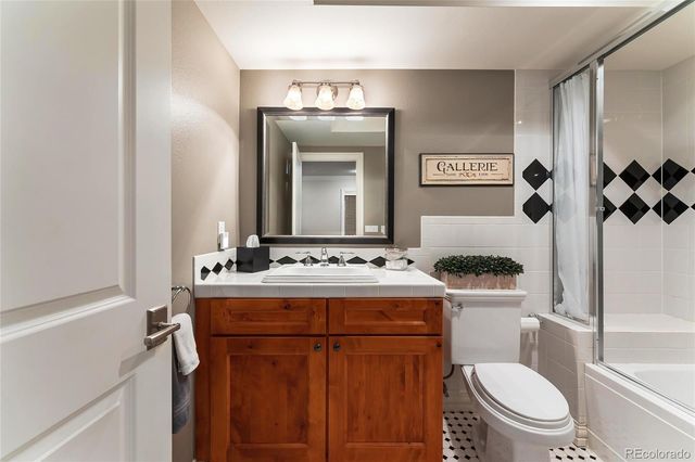 a bathroom with a toilet a sink and a mirror