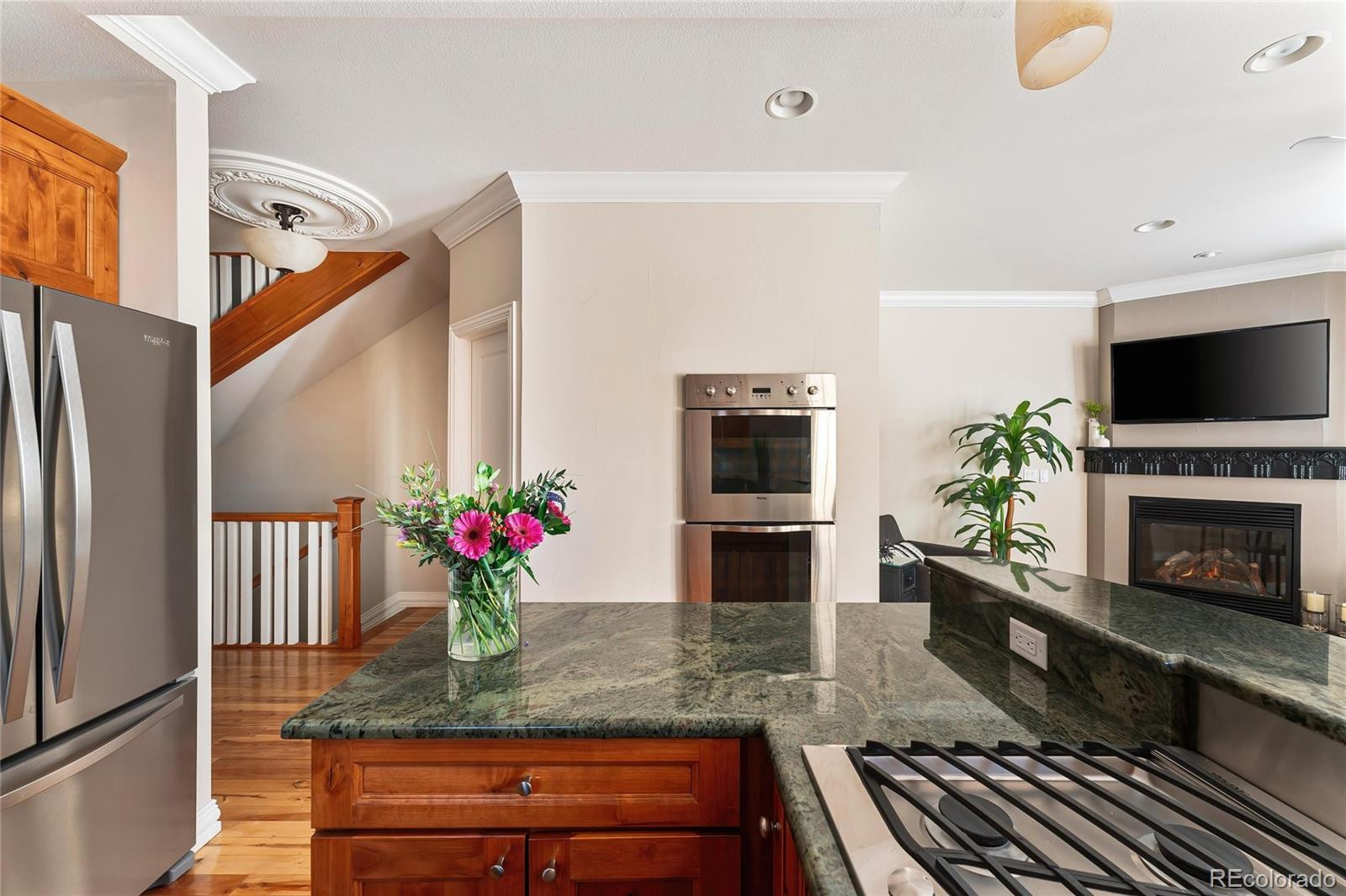 747 South Emerson Street Denver, CO 80209 - Photo 4 of 48 a kitchen with stainless steel appliances granite countertop a potted plant on the counter