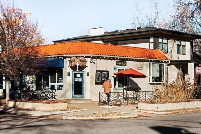 a view of backyard with table and chairs and potted plants