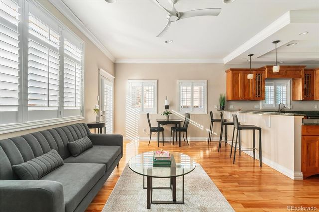 a living room with furniture a dining table and chairs with wooden floor