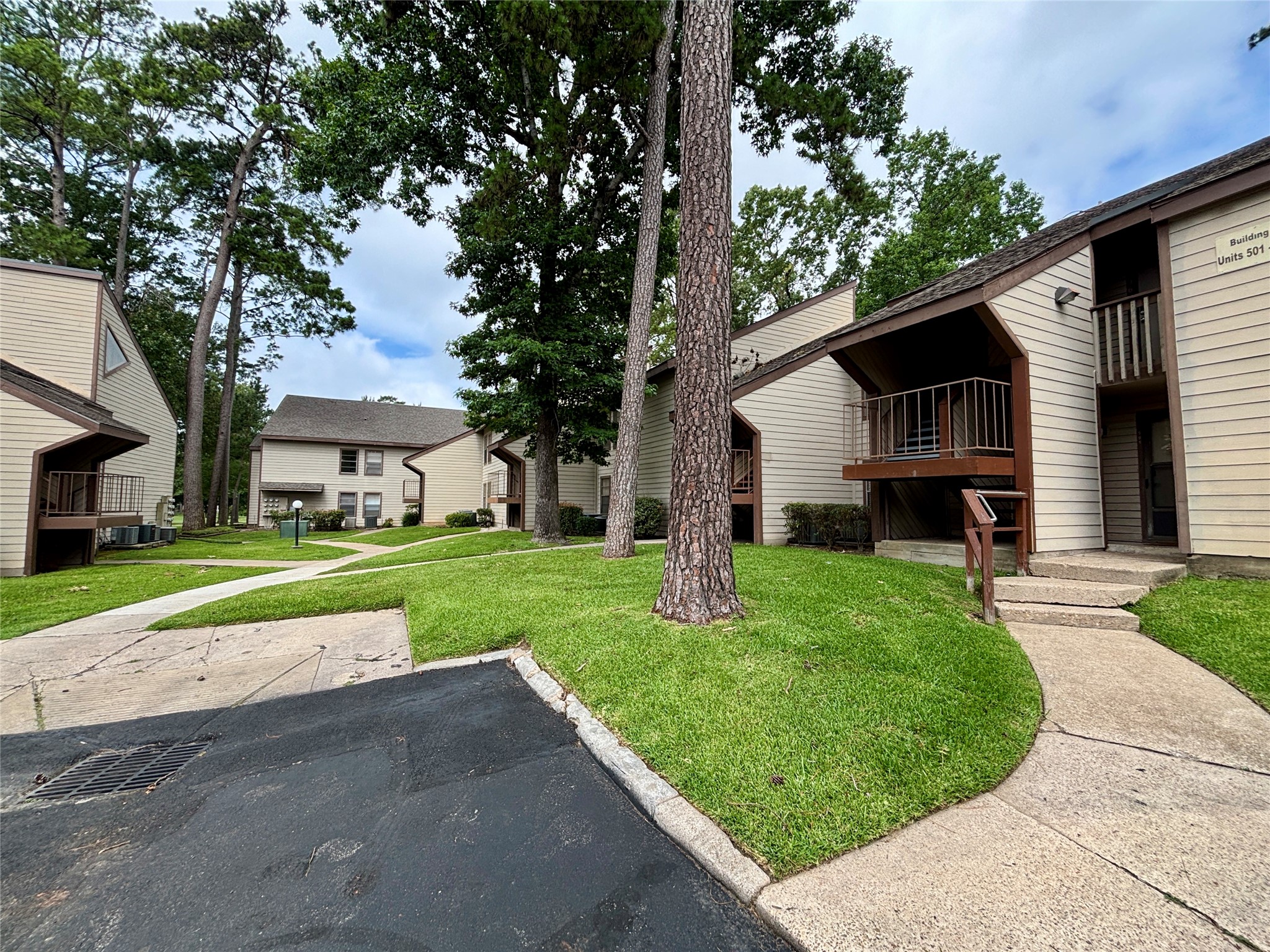 12900 Walden Road, Unit 508E Montgomery, TX 77356 - Photo 23 of 25 a front view of a house with a yard and garage