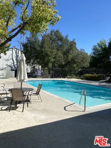 a view of a patio with a table and chairs