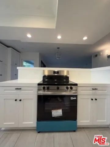 a stove top oven sitting inside of a kitchen
