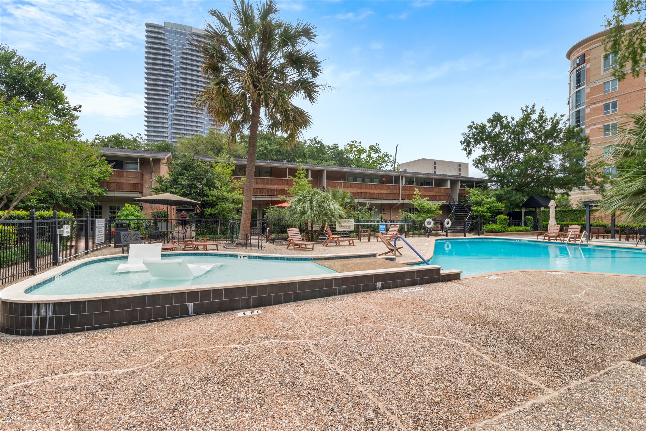 3924 West Alabama Street, Unit 4 Houston, TX 77027 - Photo 22 of 32 Beautiful pool awaits you this summer. Has pool loungers and beach area.