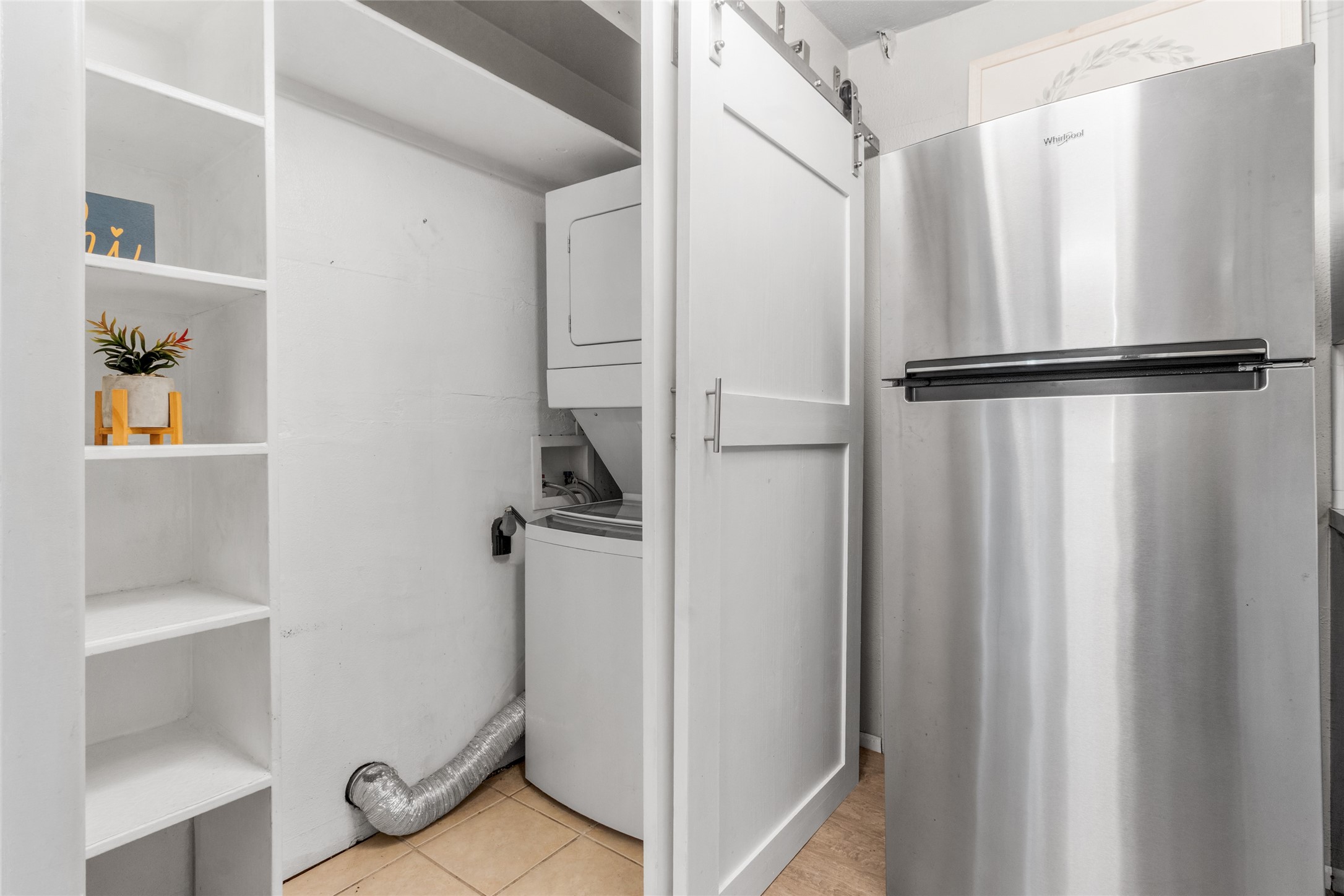 3924 West Alabama Street, Unit 4 Houston, TX 77027 - Photo 10 of 32 Refrigerator and Washer Dryer convey with home. Laundry area can accommodate a full size machines. New Barn style doors compliment this area.