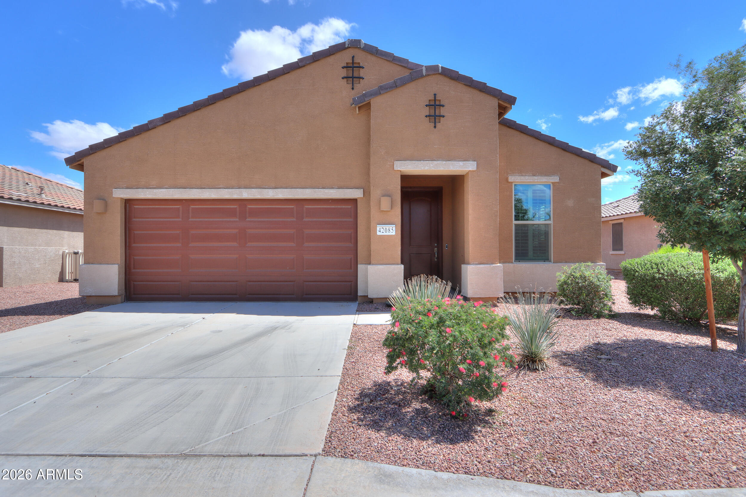 42085 West Cribbage Road Maricopa, AZ 85138 - Photo 1 of 35 a front view of a house with a yard and garage