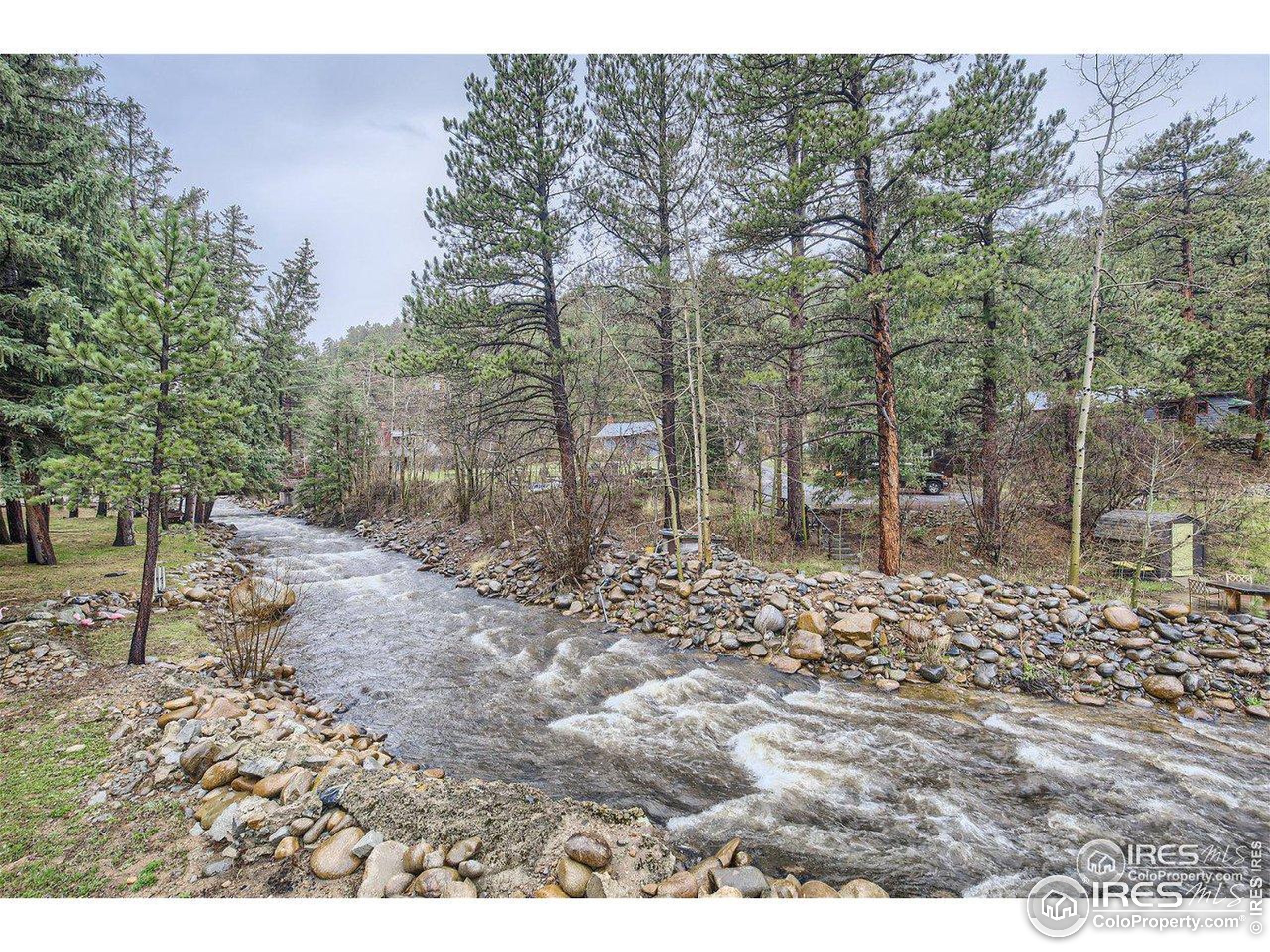 664 Riverside Drive Lyons, CO 80540 - Photo 2 of 16 a backyard of a house with lots of green space