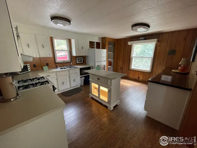 a kitchen with a stove a sink and a refrigerator