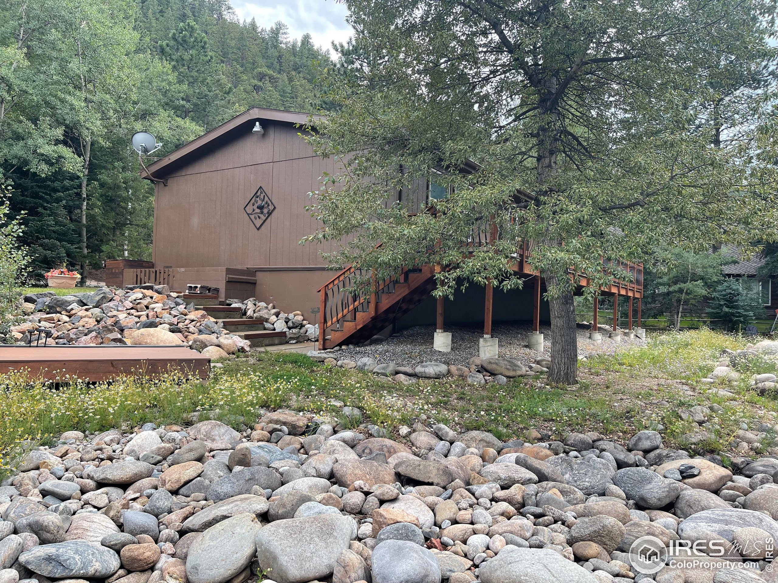664 Riverside Drive Lyons, CO 80540 - Photo 8 of 16 a view of a barn in the middle of a yard