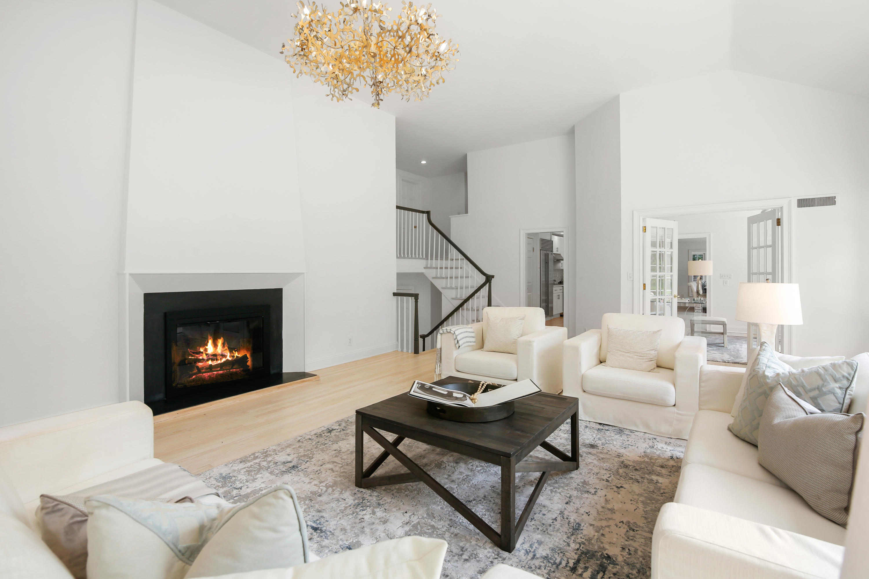 114 Colony Road Darien, CT 06820 - Photo 2 of 40 a living room with furniture a chandelier and a fireplace
