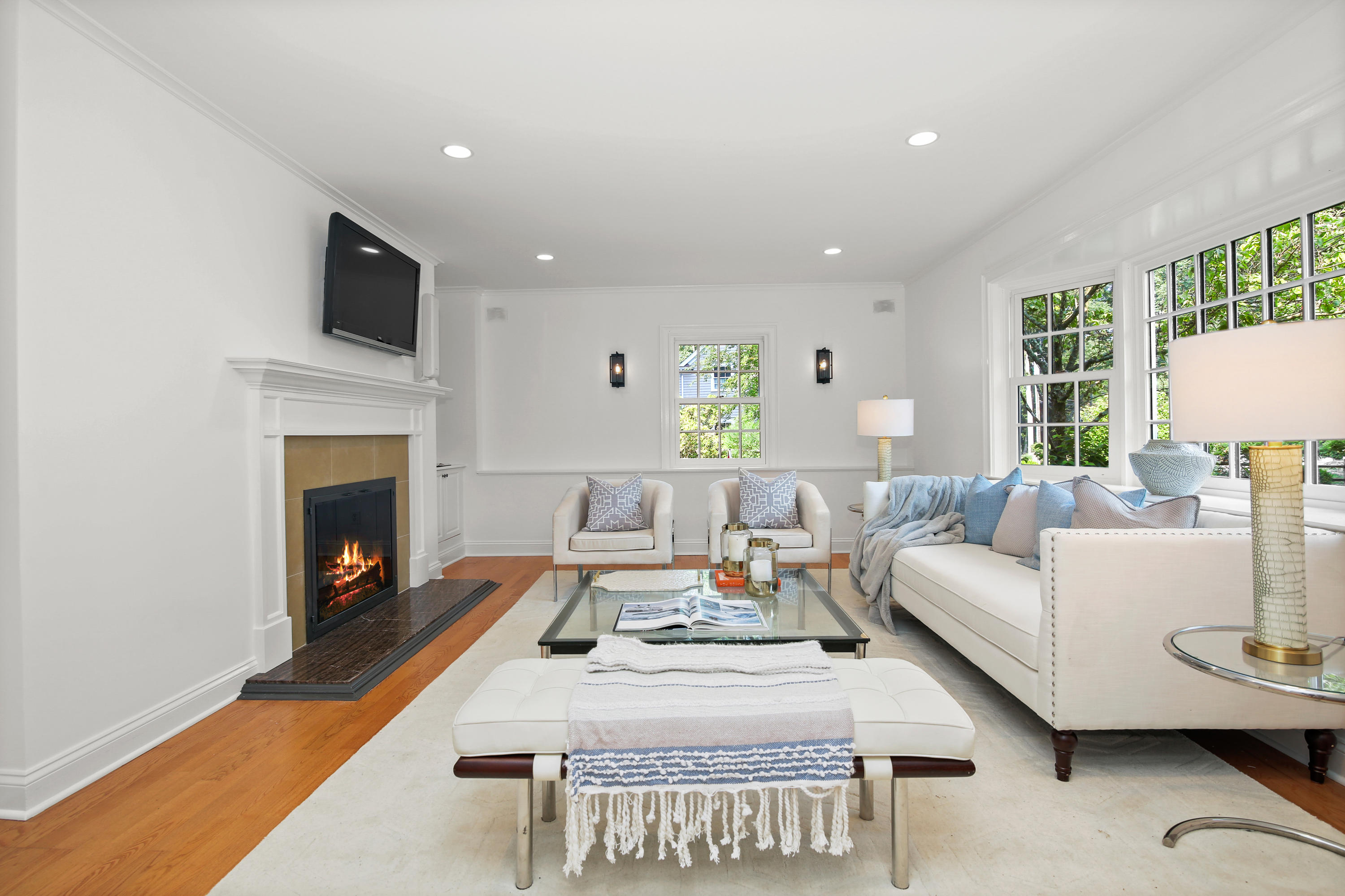 114 Colony Road Darien, CT 06820 - Photo 15 of 40 a living room with furniture a fireplace and a flat screen tv