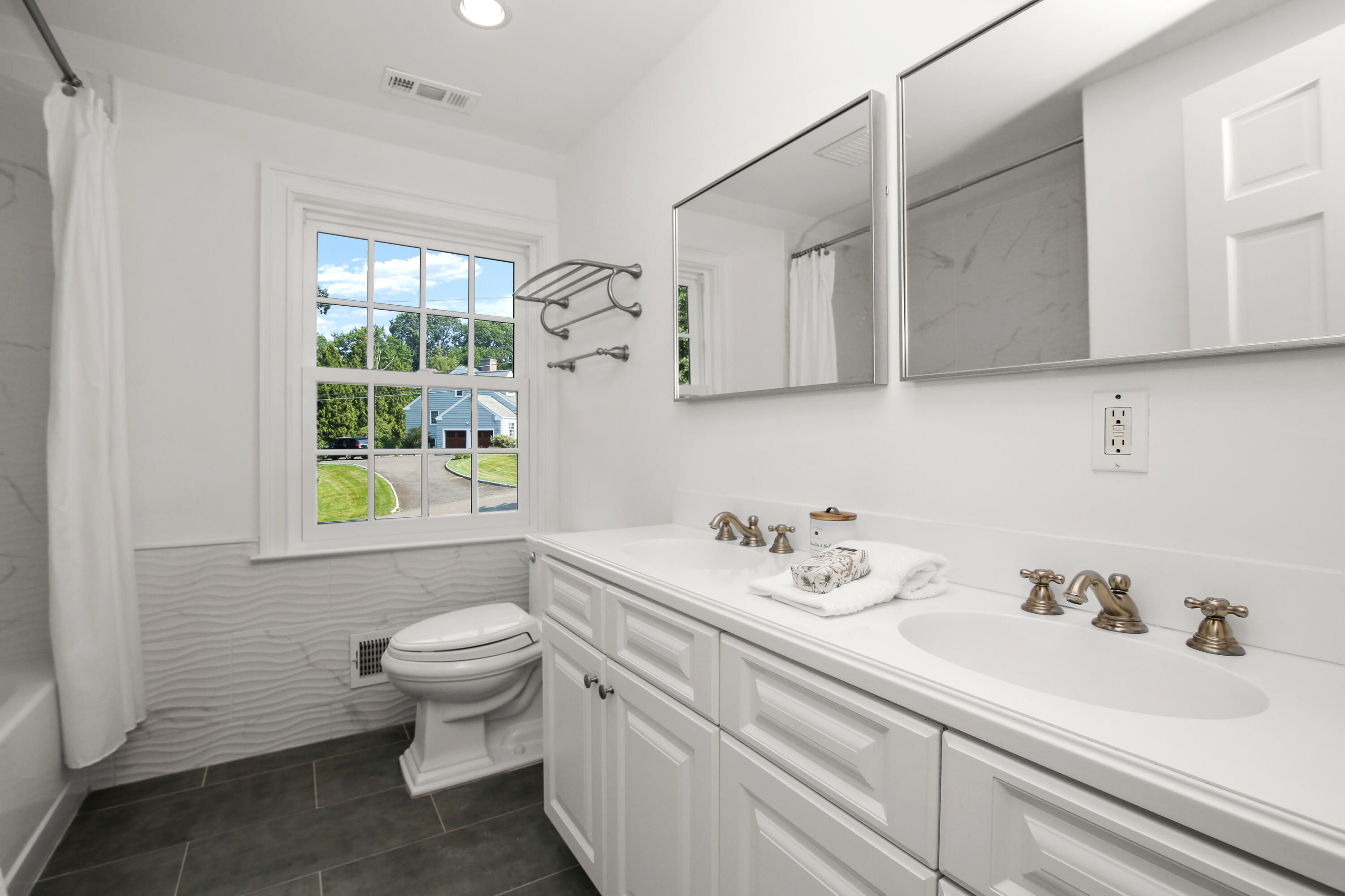 114 Colony Road Darien, CT 06820 - Photo 25 of 40 a bathroom with a sink toilet and a window