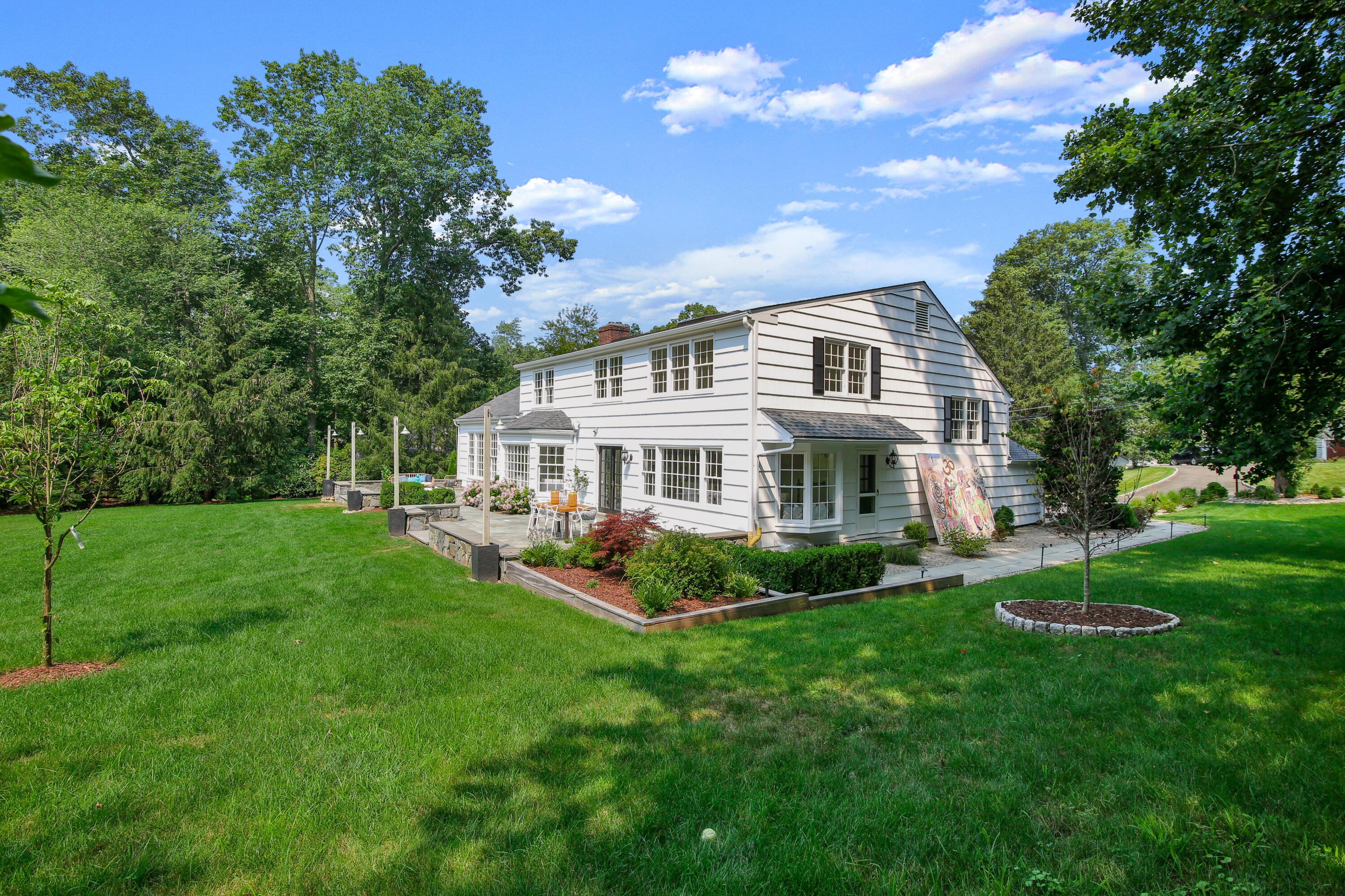114 Colony Road Darien, CT 06820 - Photo 36 of 40 a front view of a house with a yard table and chairs