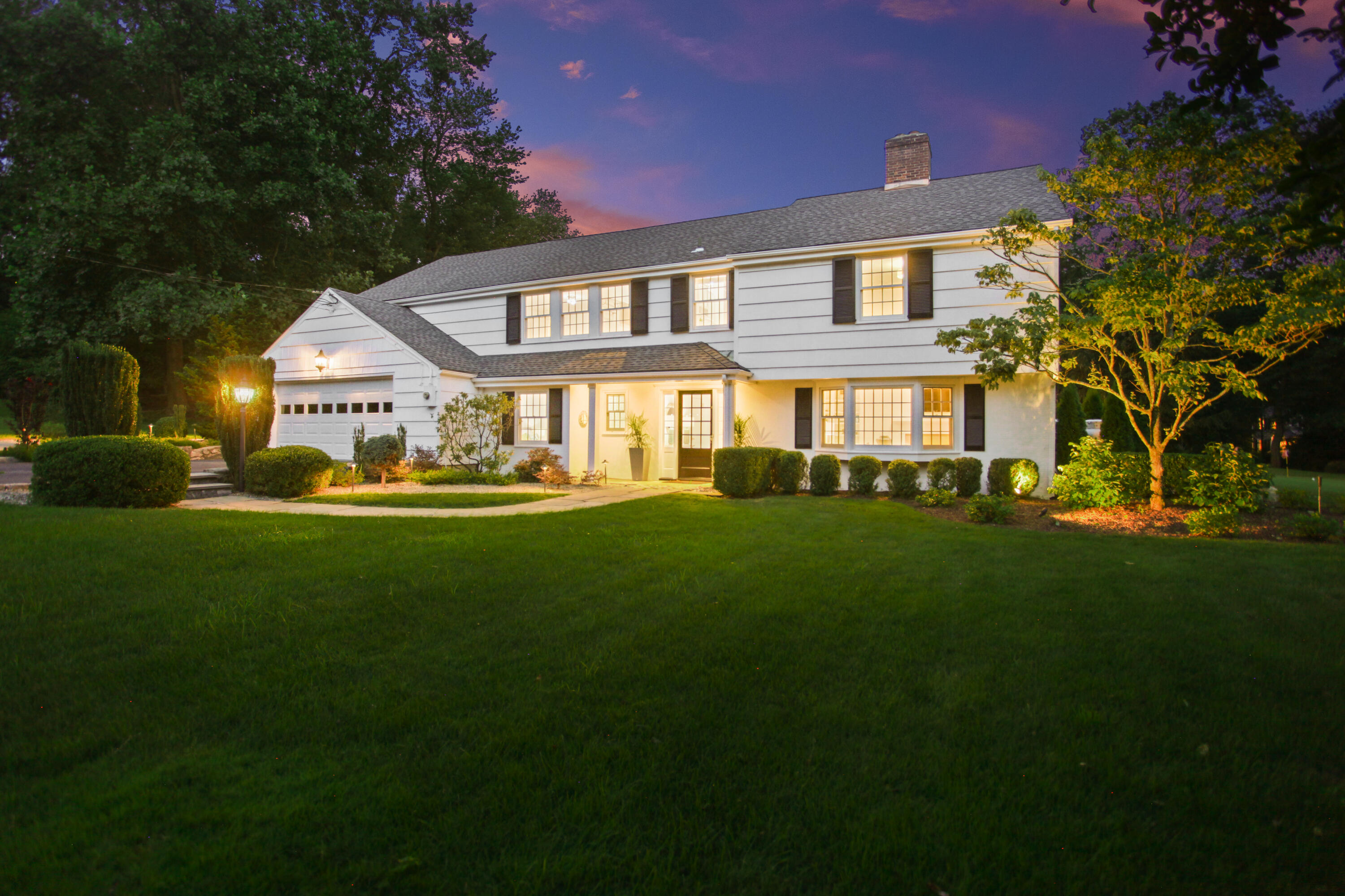 114 Colony Road Darien, CT 06820 - Photo 37 of 40 a front view of a house with a garden and porch
