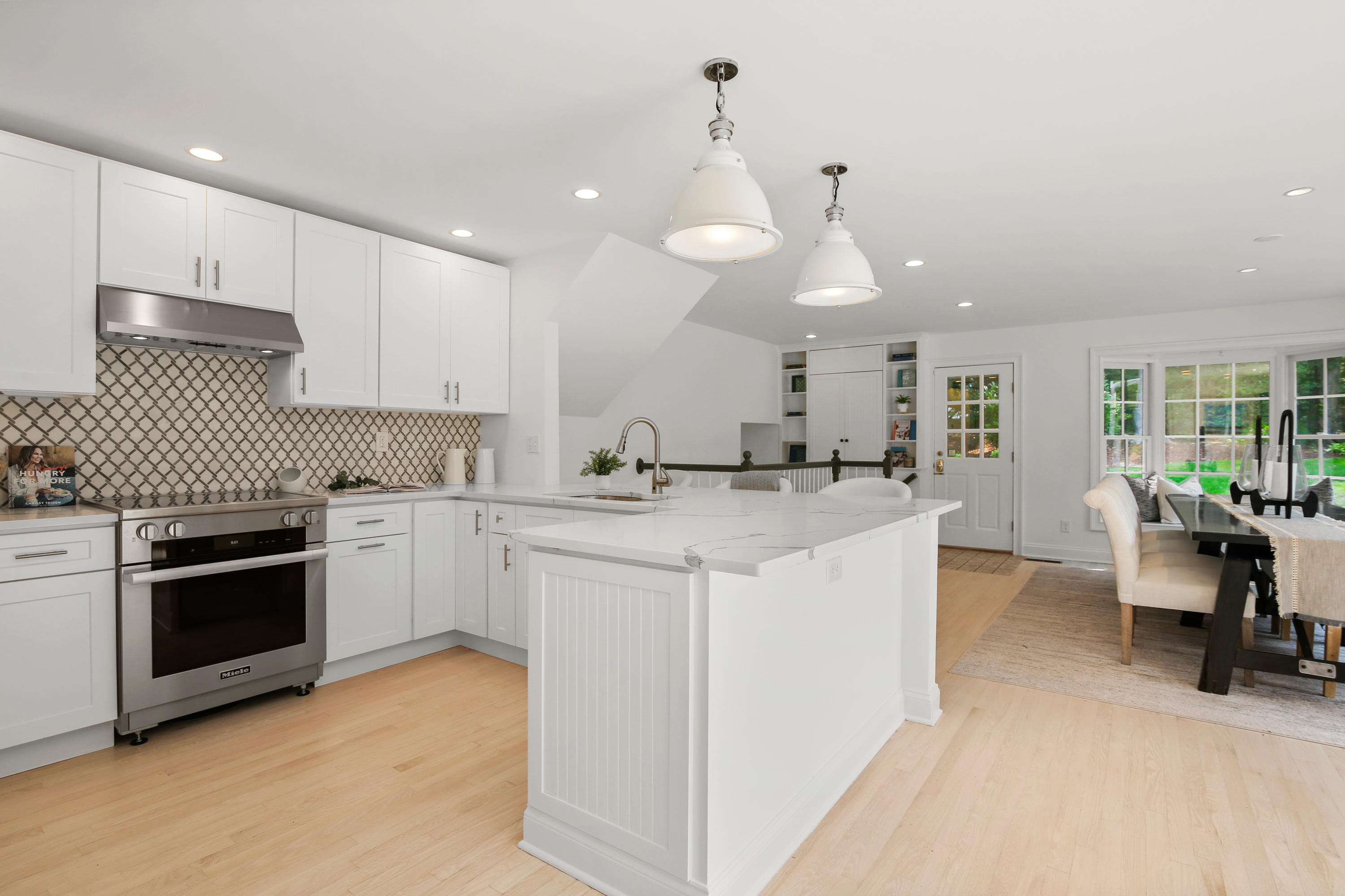 114 Colony Road Darien, CT 06820 - Photo 5 of 40 a kitchen with white cabinets and stainless steel appliances